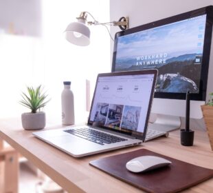 MacBook Pro on table beside white iMac and Magic Mouse